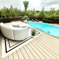 Modern composite decking with pool and seating.
