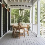a table and chairs on a slate gray deck boards of timbertech porch